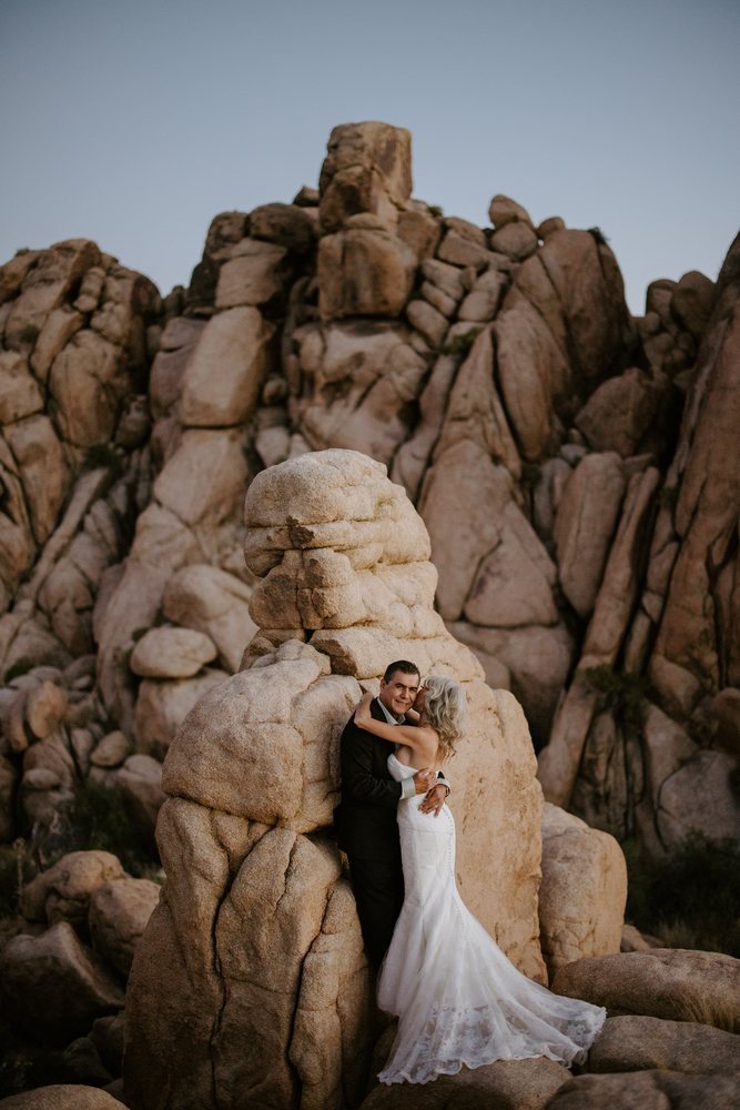 Couple forehead to forehead between two Joshua trees