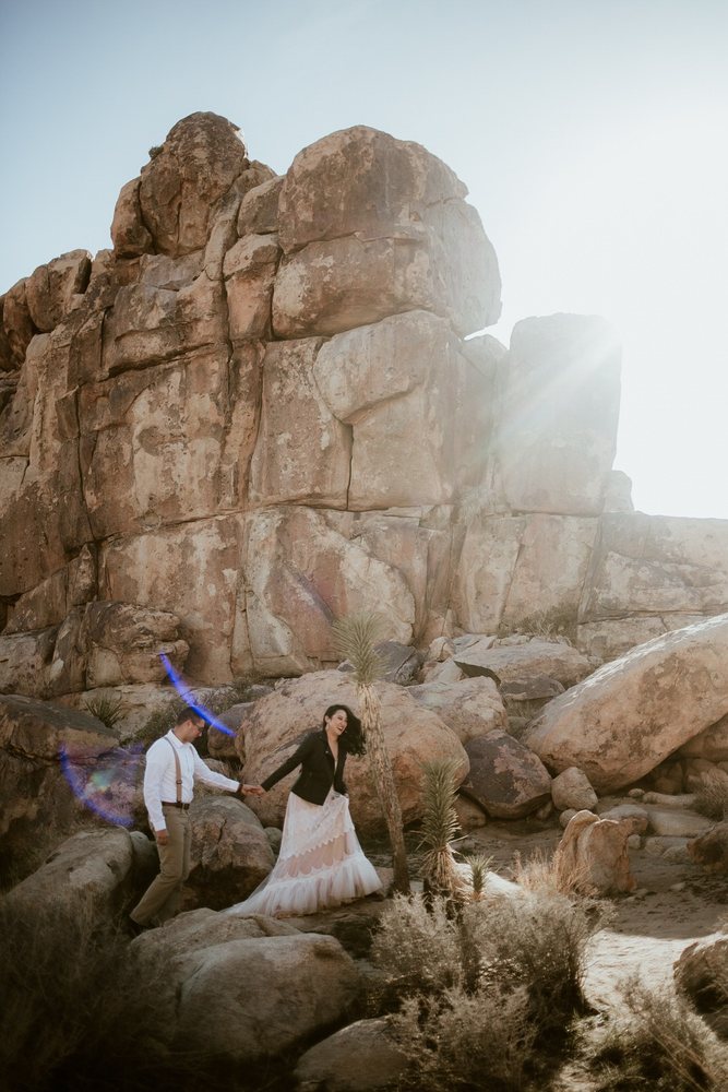 Couple on giant Joshua Tree rock formations