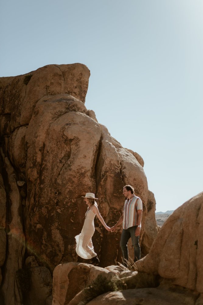 Couple walking hand in hand on the boulders