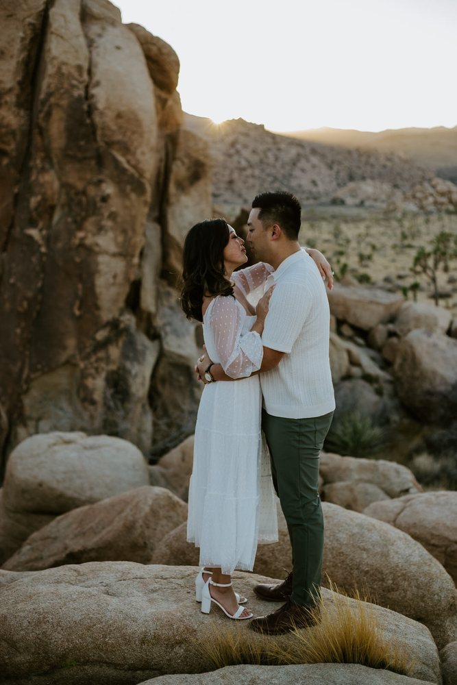 Embrace on the rocks at golden hour