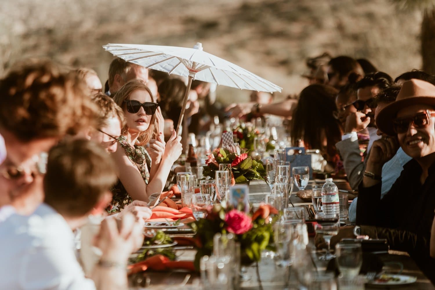 Guest under a paper parasol at the dinner table