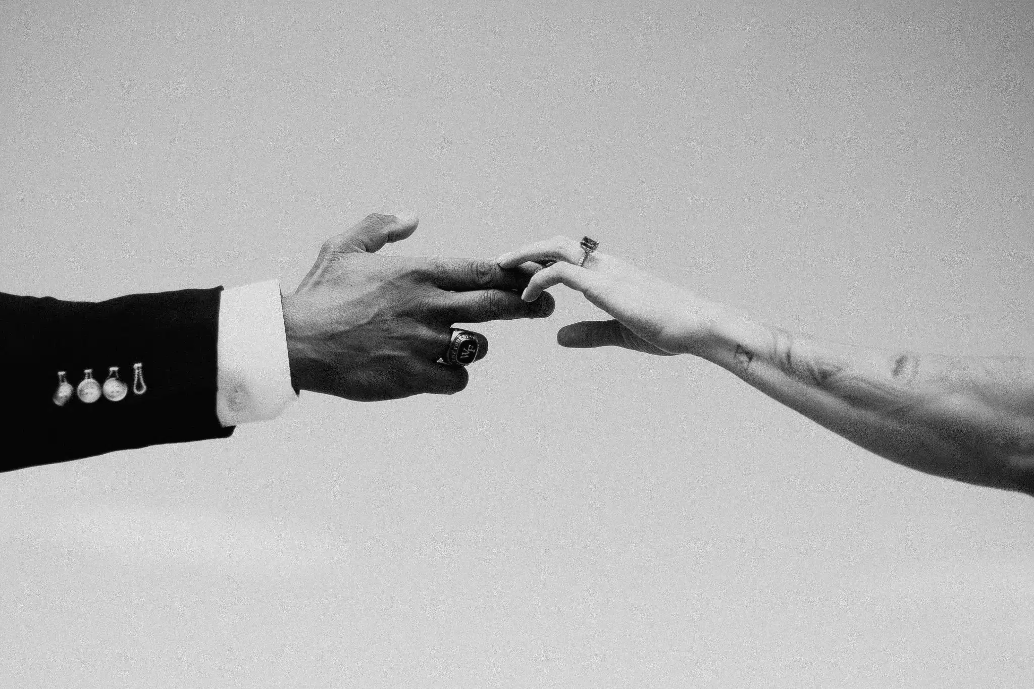 Joshua Tree elopement, hands reaching for each other in black and white