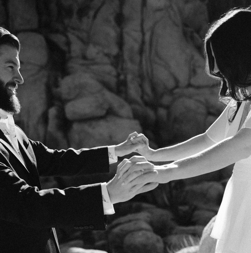 Holding hands and laughing, black and white
