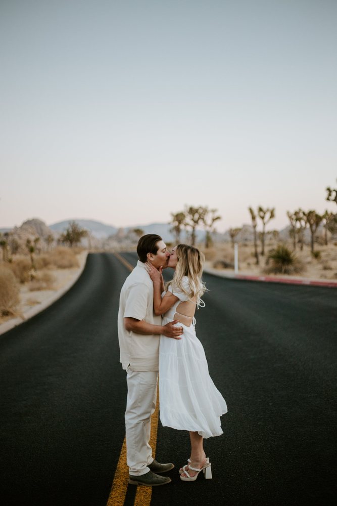 Kiss in the middle of an empty desert road