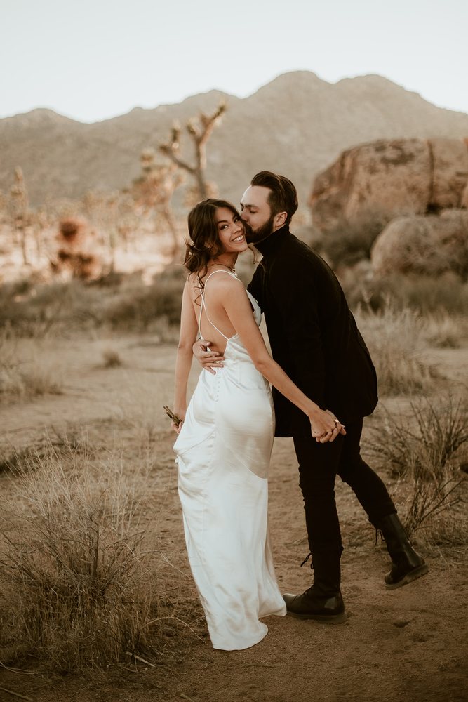 Kiss on the cheek in a satin dress