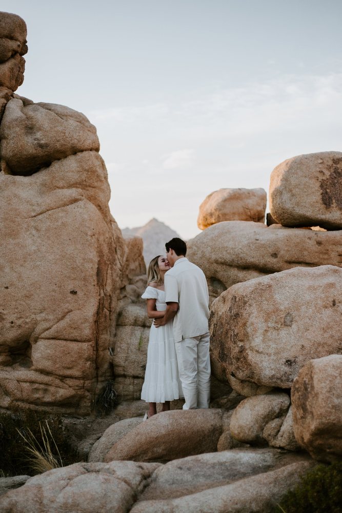 Quiet kiss tucked between the boulders