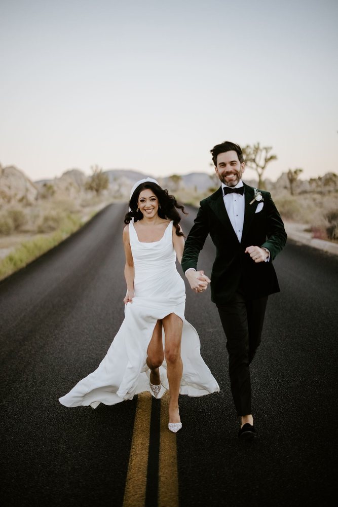 Running hand in hand down a desert road