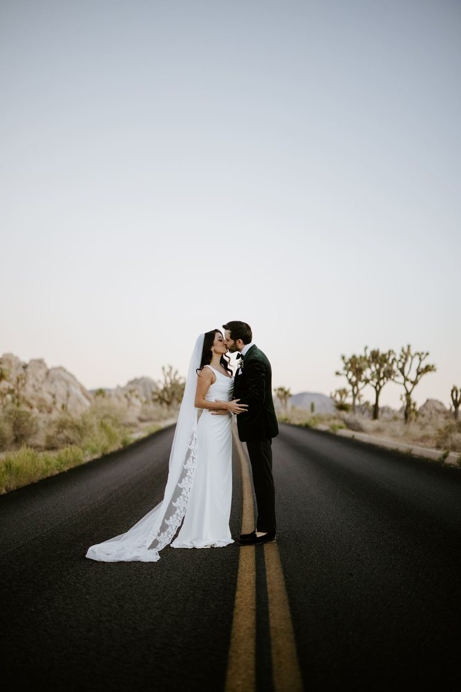 Kiss in the middle of a Joshua Tree road at dusk