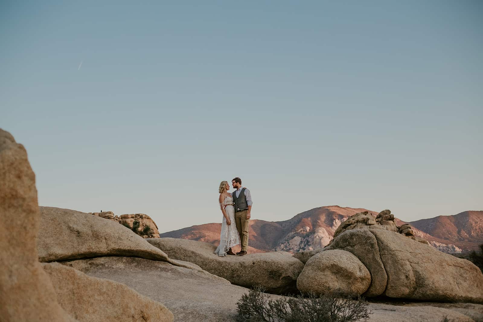 Wide view of a couple among the Joshua Tree rock formations